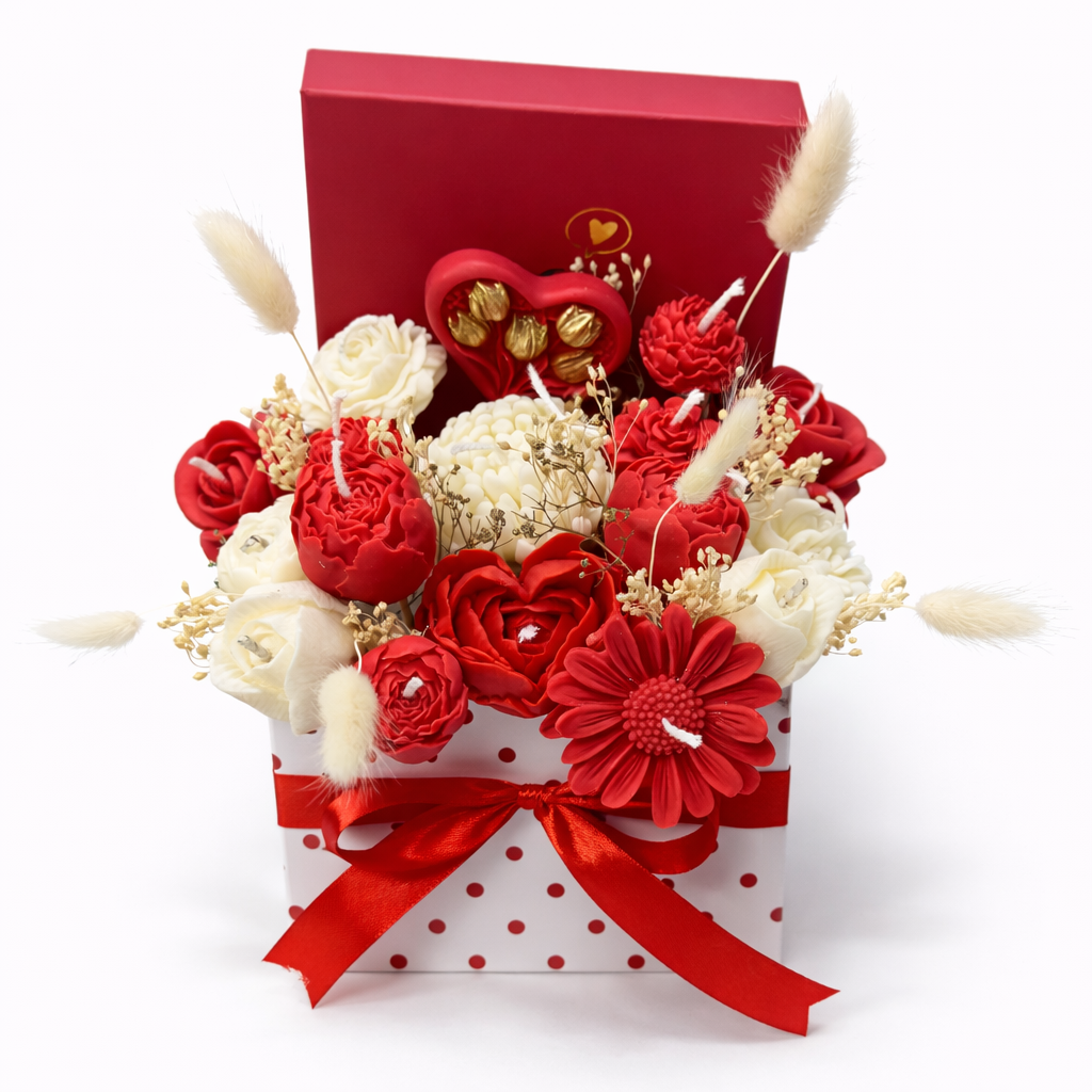Centro Infinito de cera en caja con forma de corazón, con composición floral de cera en tonos rojo y blanco, presentado como regalo romántico para pareja